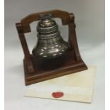 A rare cased silver presentation bell on wooden st