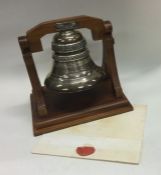 A rare cased silver presentation bell on wooden st