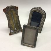 Two silver picture frames together with a baromete