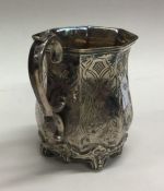 A Victorian silver cream jug with scroll decoratio