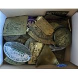 A box of mixed brass Traction engine rally badges.