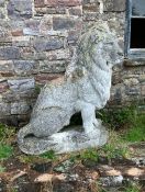 A pair of large stone lions in seated position. Ap
