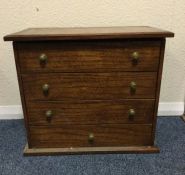 A small oak four drawer chest.