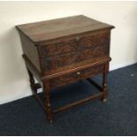 An Antique oak hinged top box on stand.