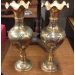 A tall pair of brass vases.