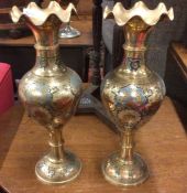 A tall pair of brass vases.