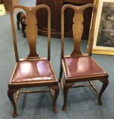 A pair of Queen Anne dining chairs.