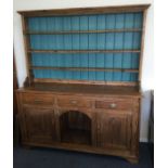 A large striped pine kitchen dresser.