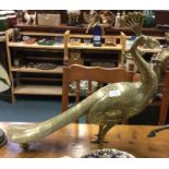 A large brass figure of a bird.