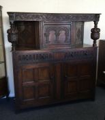 A large hinged top court cupboard.