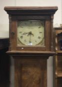 An antique elm Grandfather clock.