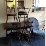 A good table with five chairs of Ercol design.