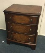A reproduction mahogany chest of drawers.