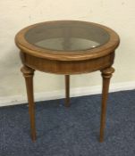 A small glass mounted occasional table.