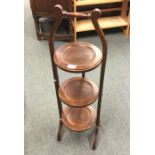 A mahogany cake stand.