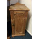 A stripped pine bedside cabinet.