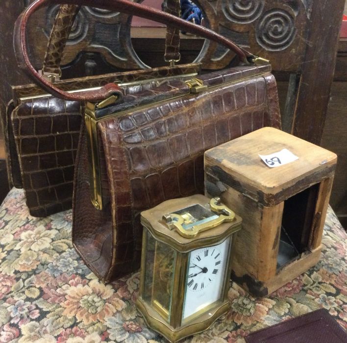 A ladies handbag together with a carriage clock.