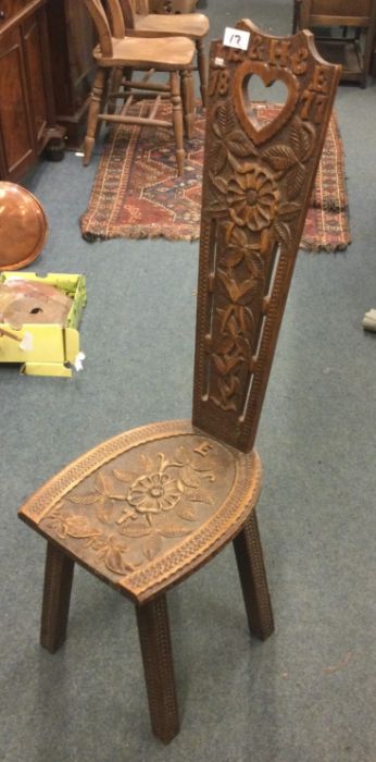 A carved oak hall chair.