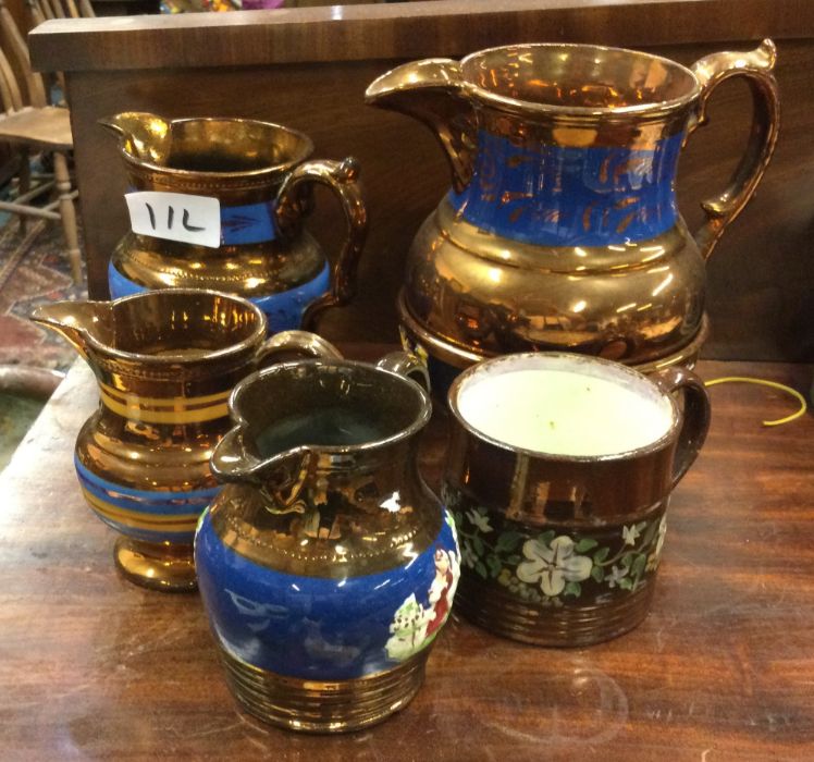 A group of lustre jugs.
