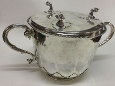 An early style silver porringer and stand. Britann