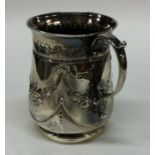 An Edwardian silver mug decorated with flowers and