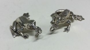 A pair of silver figures of frogs. Marked to bases