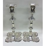 A good pair of cast silver candlesticks with crest