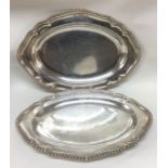 A pair of oval George III silver dinner plates engraved with a c