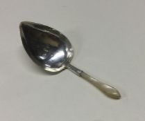 A George III silver and MOP caddy spoon. Birmingha