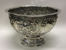 An embossed silver rose bowl decorated with figure