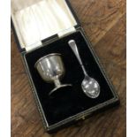 A cased silver egg cup together with matching spoo