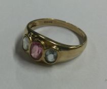 A 9 carat three stone gypsy set ring. Approx. 2 gr