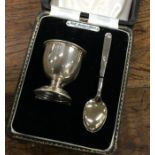 A cased silver egg cup together with matching spoo