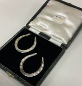A good pair of heavy silver napkin rings in the fo