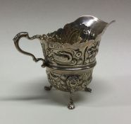A silver cream jug chased with animals. Chester 19