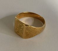 A small 9 carat signet ring with engraved decorati