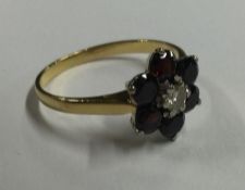 An Antique garnet and diamond cluster ring in 18 c
