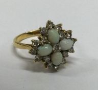 A large 18 carat gold opal and diamond cluster rin