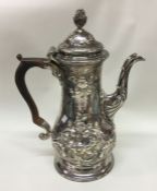 A chased George III silver coffee pot. London 1769