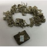 A heavy silver charm bracelet together with a stam