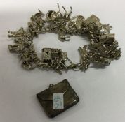 A heavy silver charm bracelet together with a stam