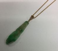 An Antique jade drop pendant on high carat fine li