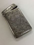 An engraved silver card case decorated with a hear