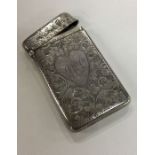 An engraved silver card case decorated with a hear