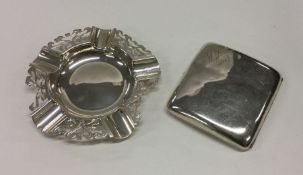 A silver ashtray together with a silver cigarette