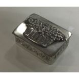 A chased silver box decorated with a basket of flo