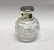 A silver mounted glass scent bottle. London 1926.