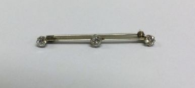 A good diamond three stone brooch in white gold knif