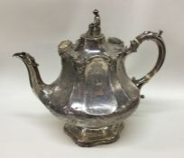 A good Chinoiserie engraved silver teapot. London
