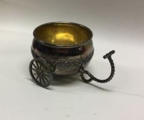 A novelty silver miniature cart on wheels. Marked
